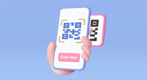 Ręka trzyma telefon, na którym wyświetlony jest kod QR. Widoczny jest przycisk "Scan Here", pokazujący, jak się skanuje kod QR telefonem.