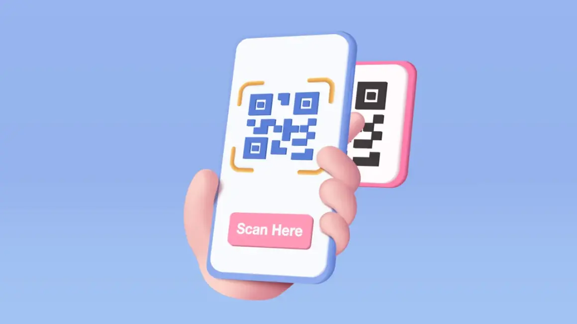 Ręka trzyma telefon, na którym wyświetlony jest kod QR. Widoczny jest przycisk "Scan Here", pokazujący, jak się skanuje kod QR telefonem.