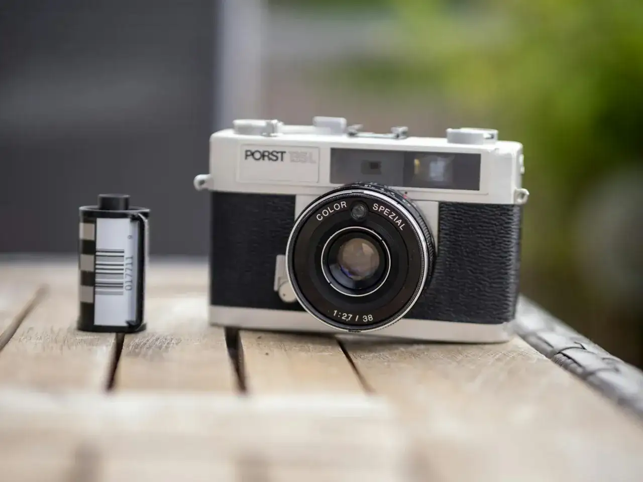 Porst 135L z rolką filmu obok. Klasyczna fotografia analogowa, gotowa do uchwycenia wspomnień.
